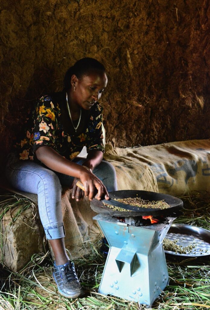If you think a pour-over is slow — wait until you get to Ethiopia. Often when you order a coffee (or "buna," as it is known locally) the beans are ceremoniously first roasted in front of you, ground with a hollowed out log and pestle, and then brewed. It’s a wonderful experience, and the 30-minute process sharply contrasts with the instant convenience store coffee we are familiar with in the U.S. A woman sitting down roasts coffee beans over a fire.