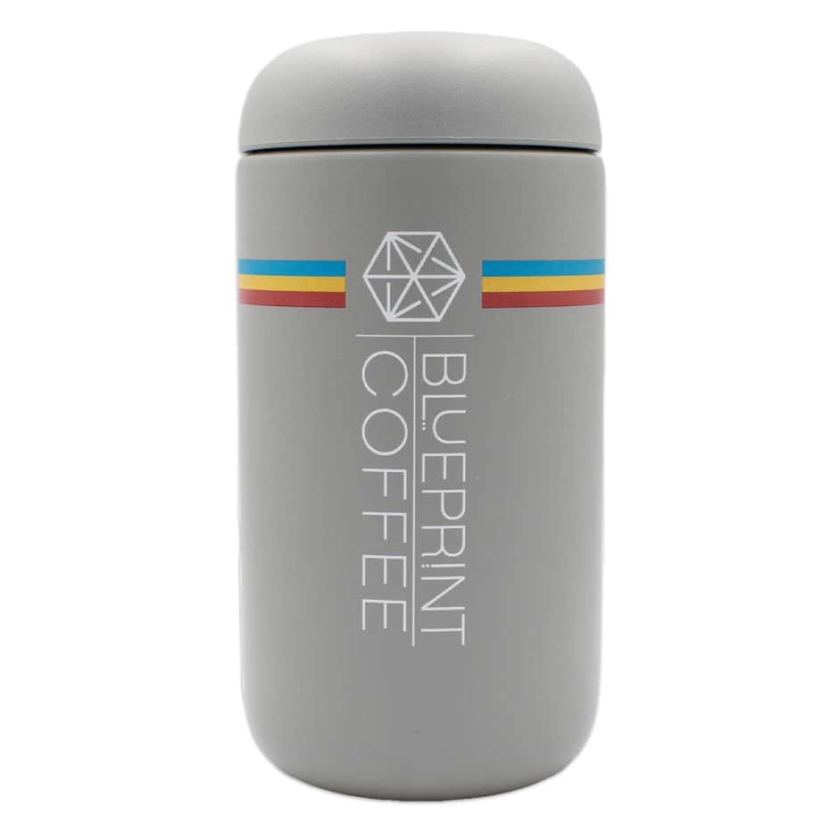 A 12-ounce grey insulated coffee tumbler with the blueprint branding.