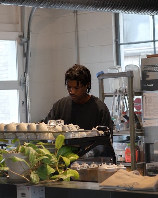 Micah jpg Micah behind the espresso machine at Watson