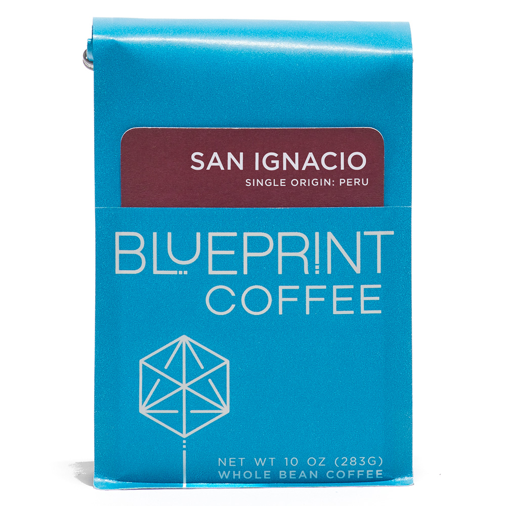 A blue 10-ounce bag of San Ignacio, Peru coffee beans featuring the Blueprint Coffee Logo and a red removable info card.